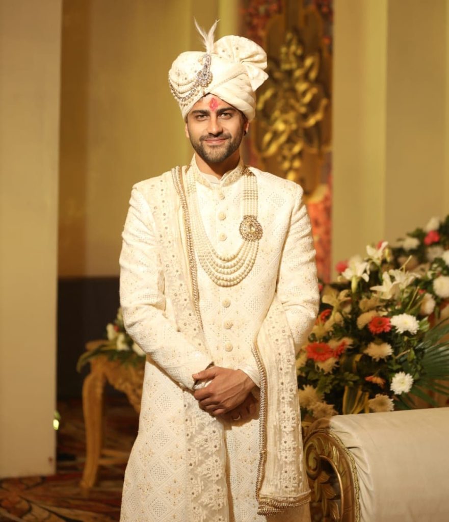 "Cream-colored sherwani as a regal wedding dress for men, showcasing intricate embroidery and traditional design elements."