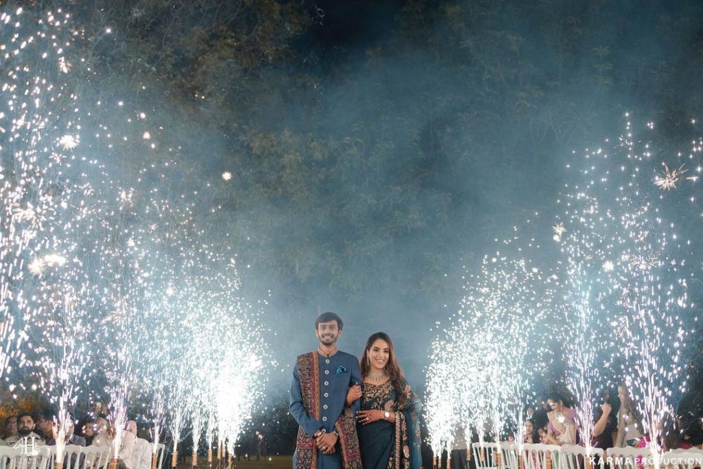 "Enchanting bride and groom entry with a fog-filled pathway and elegant decor by Saraswati Events."