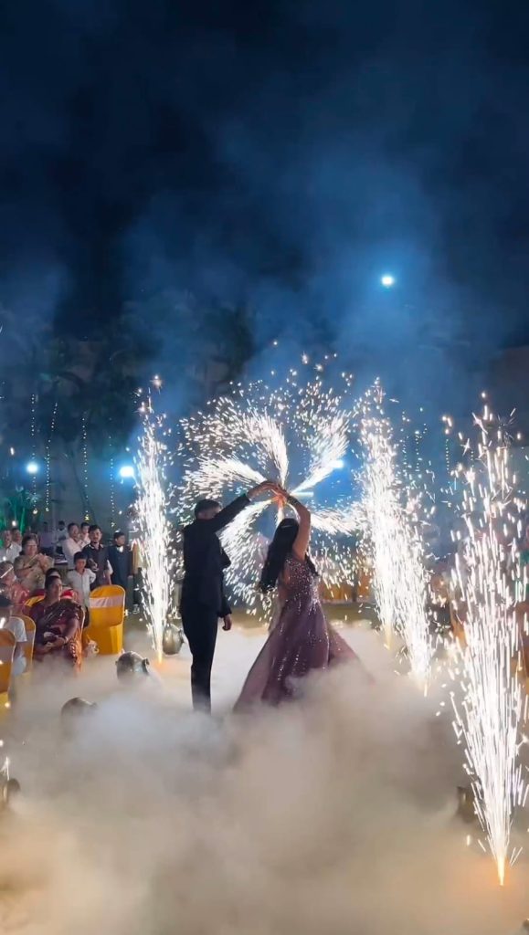 "Bridal couple making a grand bride and groom entry through a fog-filled walkway"